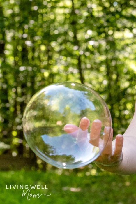 A large bubble on the tip of a person's finger. 