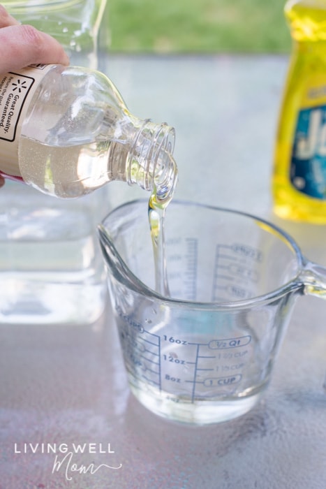 Corn syrup being poured into a measuring cup.