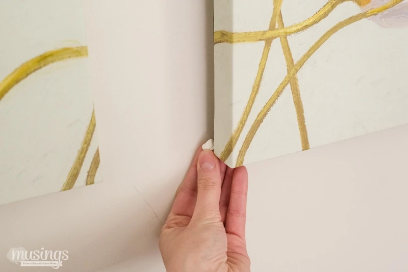 The unbelievably simple picture hanging tip you MUST try: the easy way to keep canvases, paintings, pictures & and more hanging evenly on your wall!