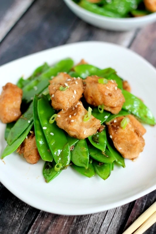 This tasty recipe for Ginger Chicken and Snowpeas is easy to make and ready in less than 20 minutes - a delicious dinner after a busy day!