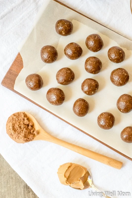 chocolate protein balls on a lined cutting board