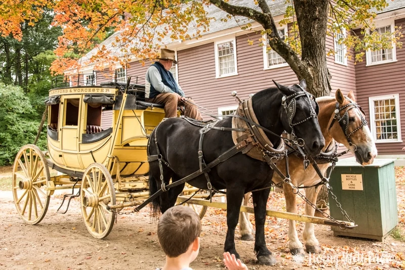 A horse drawn carriage in front of a house