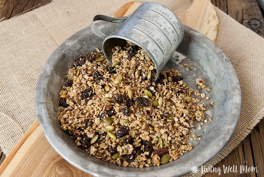 With oats, nuts, dried fruit, maple syrup, pumpkin pie spice, pumpkin, and more, this gluten free Pumpkin Spice Granola is a deliciously filling snack the whole family will love. Plus it takes less than 30 minutes to make!