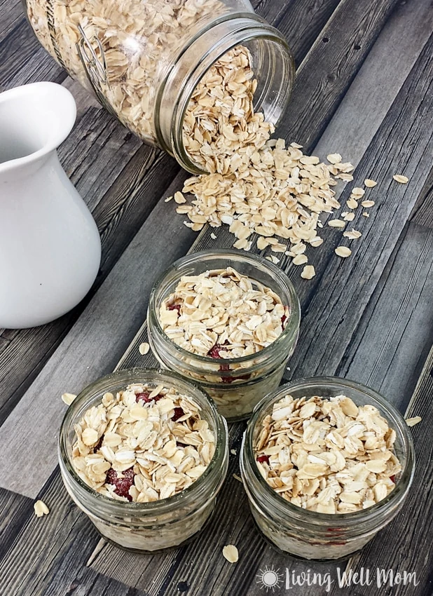 gluten free oats spilled on a counter next to jars of oatmeal