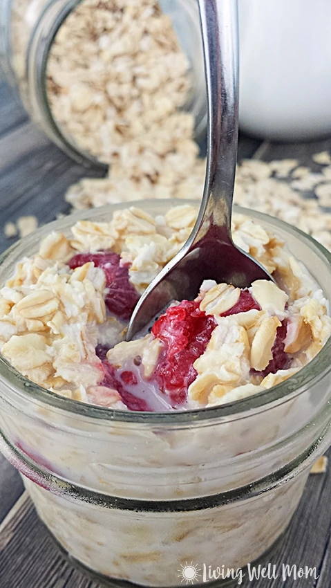 small jar of raspberry oatmeal with a spoon dipping in