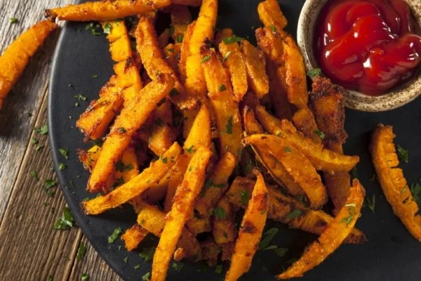 oil free pumpkin french fries on a plate with ketchup dipping sauce