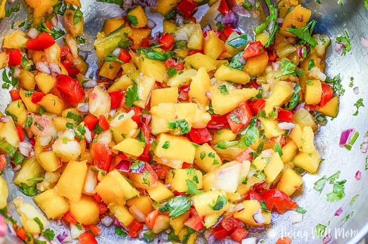 With simple, wholesome ingredients, this recipe for Coconut Crusted Salmon with Mango Pineapple Salsa will transport you to a tropical getaway, even though it's simple enough to make on a busy weeknight. | Paleo friendly