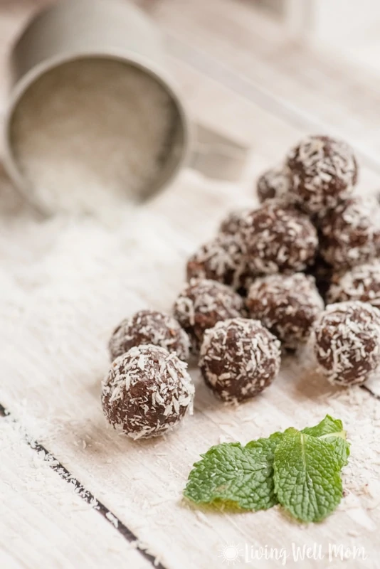 chocolate mint energy balls next to mint leaves
