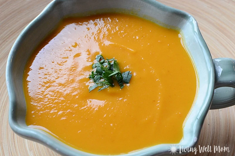 Thai Butternut Squash Soup is comfort food in a bowl without the guilt. You'll never guess this satisfying creamy fall soup is Paleo friendly and oh so easy to make!