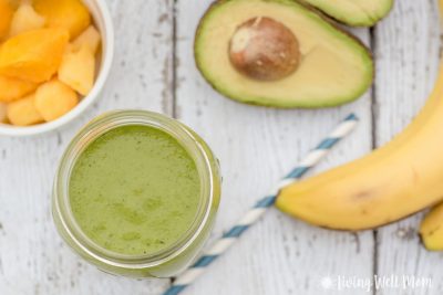 green smoothie with tropical fruit like peaches, avocado, and banana