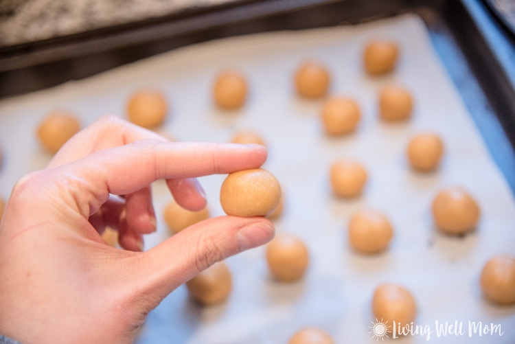 Woman rolling paleo buckeyes into ball shapes