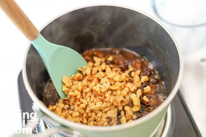 adding walnuts to recipe mixture