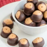 paleo buckeyes cookies on white plate with red place napkin