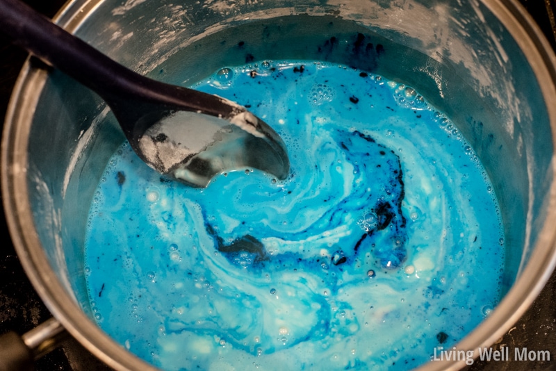 Gluten-free playdough ingredients being combined with a black mixing spoon