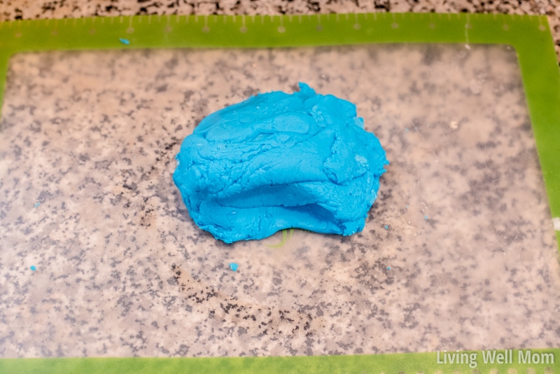 A lump of blue play-doh on a silicone baking sheet