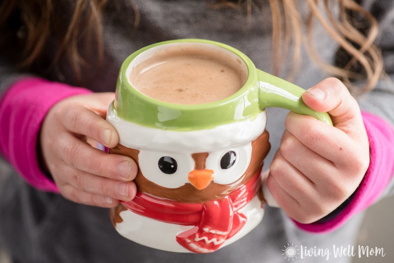 girl holding owl mug filled with homemade hot cocoa
