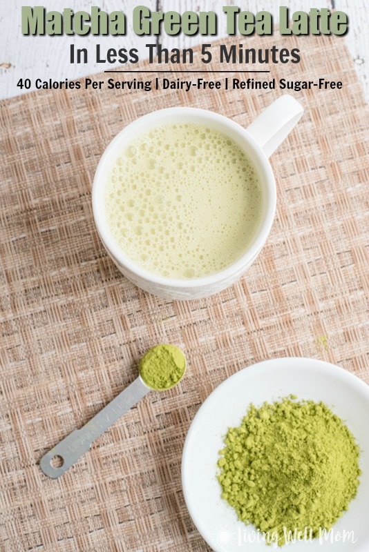 white mug with matcha latte and matcha green tea powder in white bowl and spoon