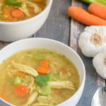 A bowl of food on a table, with Chicken and Soup