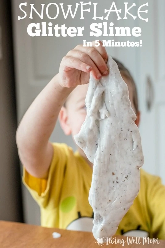 young boy playing with snowflake glitter slime