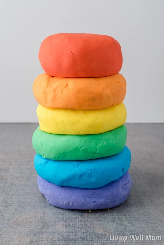 A stack of DIY play-doh in rainbow colors
