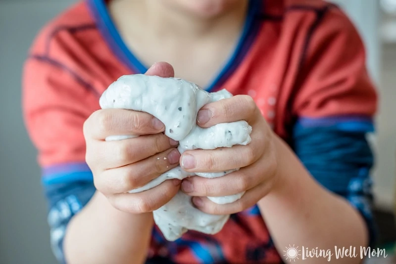 a boy holding a big ball of homemade slime in his hands