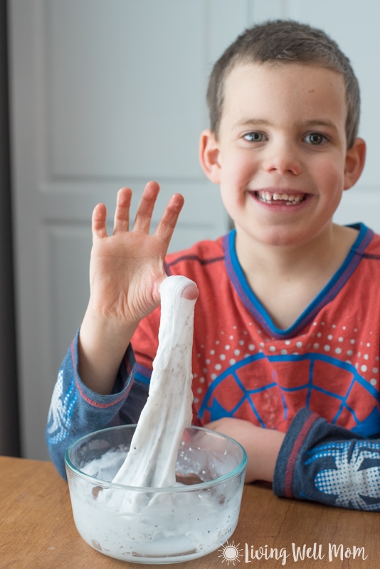 kid pulling stretchy DIY slime from a bowl