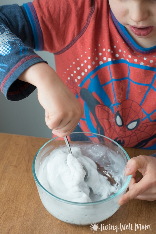 boy stirring as mixture thickens to a slimy texture