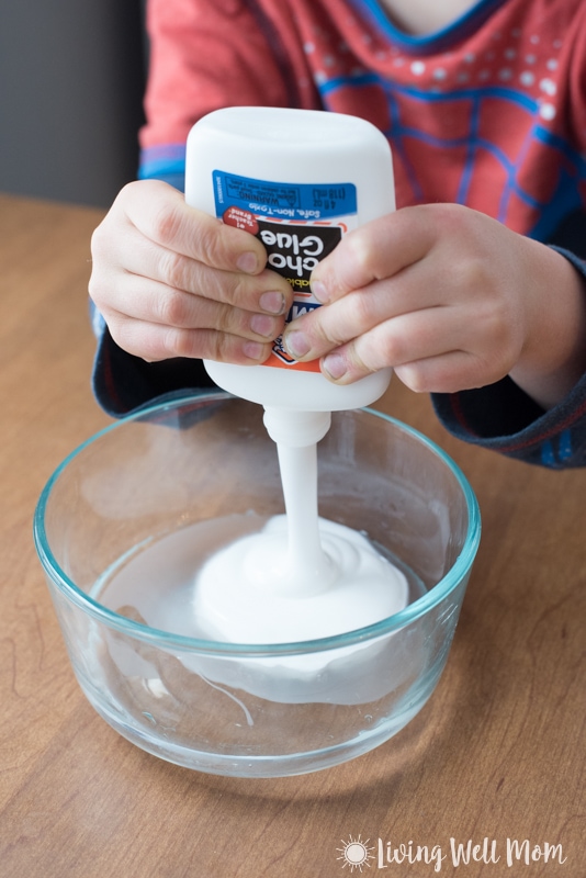 Elmer's school glue being squeezed out into a clear bowl