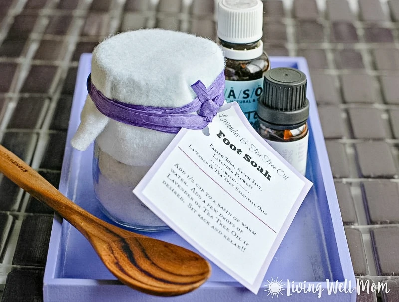 homemade lavender foot soak with label in purple tray with essential oils