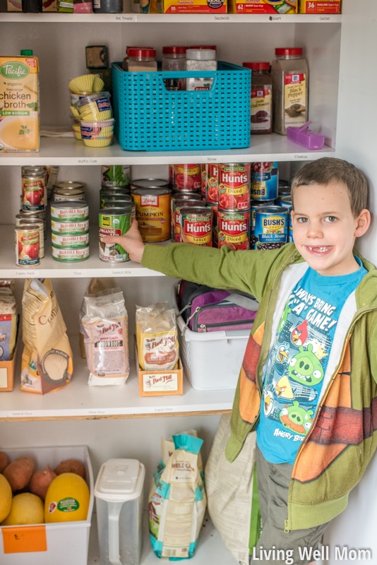 Young child helping with pantry organization