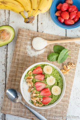 Green smoothie bowl with banana, coconut, walnuts, and strawberries on top