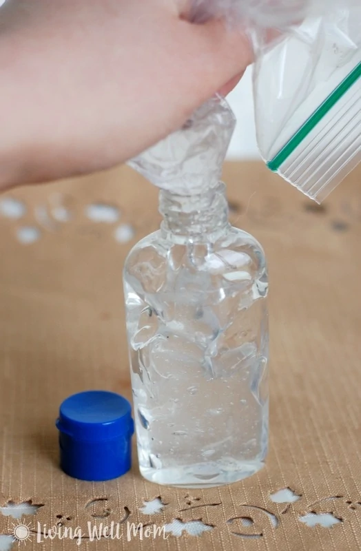 squeezing homemade hand sanitizer gel into small bottle from a plastic zippered bag