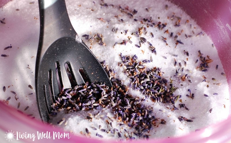 homemade Epsom salt foot scrub mixture with dried lavender and black spoon