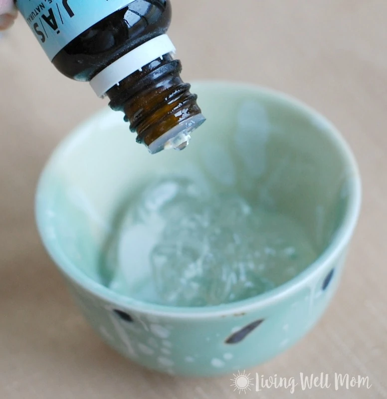 adding tea tree oil to gel in a small bowl