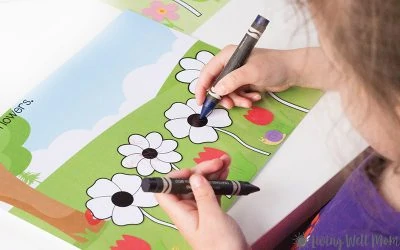 child coloring flowers with crayons