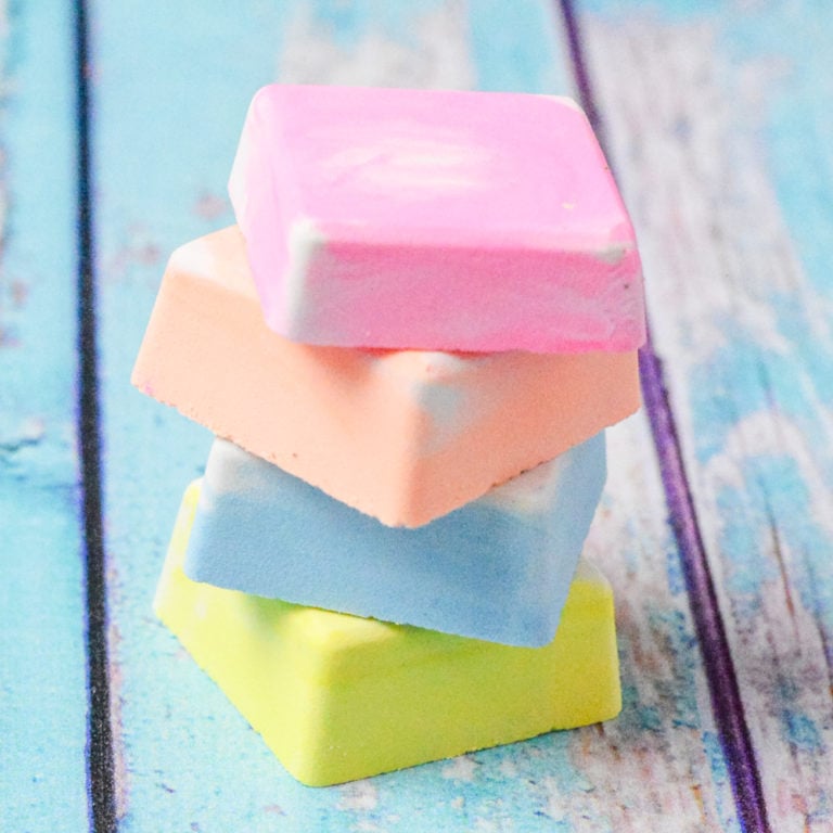Colorful squares of DIY sidewalk chalk on a wooden surface.