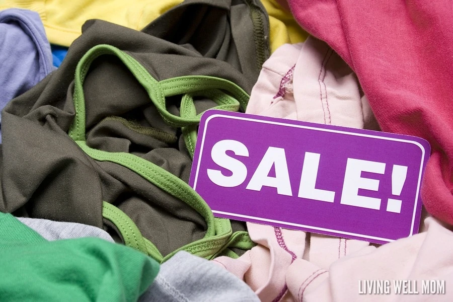 Purple sale sign on a pile of clothing