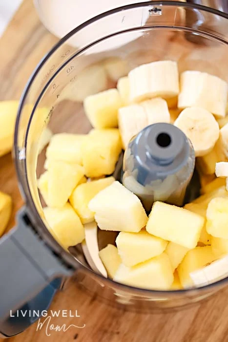 Fruit mixture of bananas and pineapple in a food processor. 