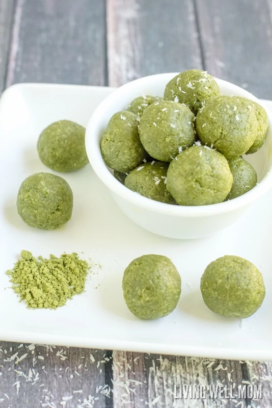 A bowl of matcha green tea energy balls with shredded coconut on top