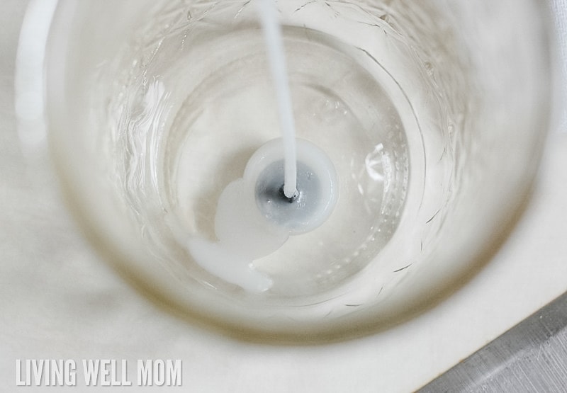 placing wick in the base on the repurposed glass jar