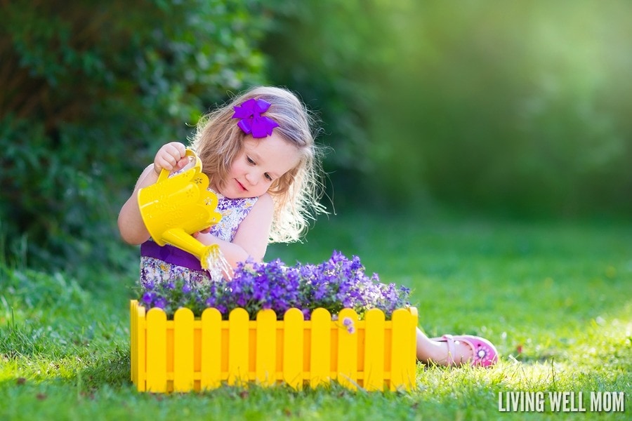 little girl watering garden