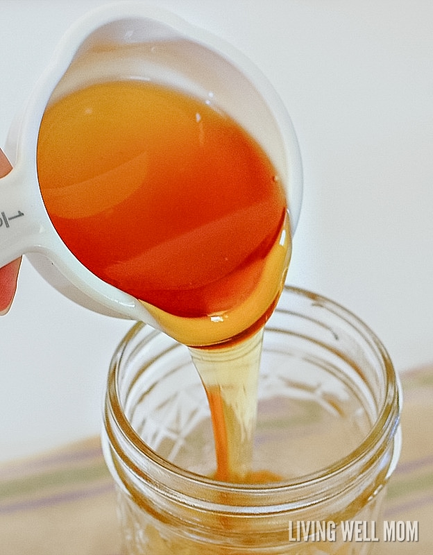 Adding honey to a mason jar for lavender face wash recipe