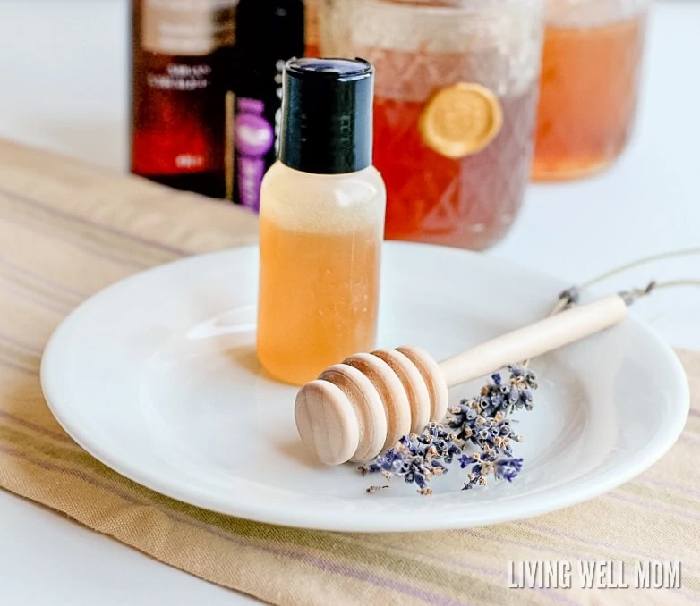 bottle of homemade honey face wash with a sprig of lavender