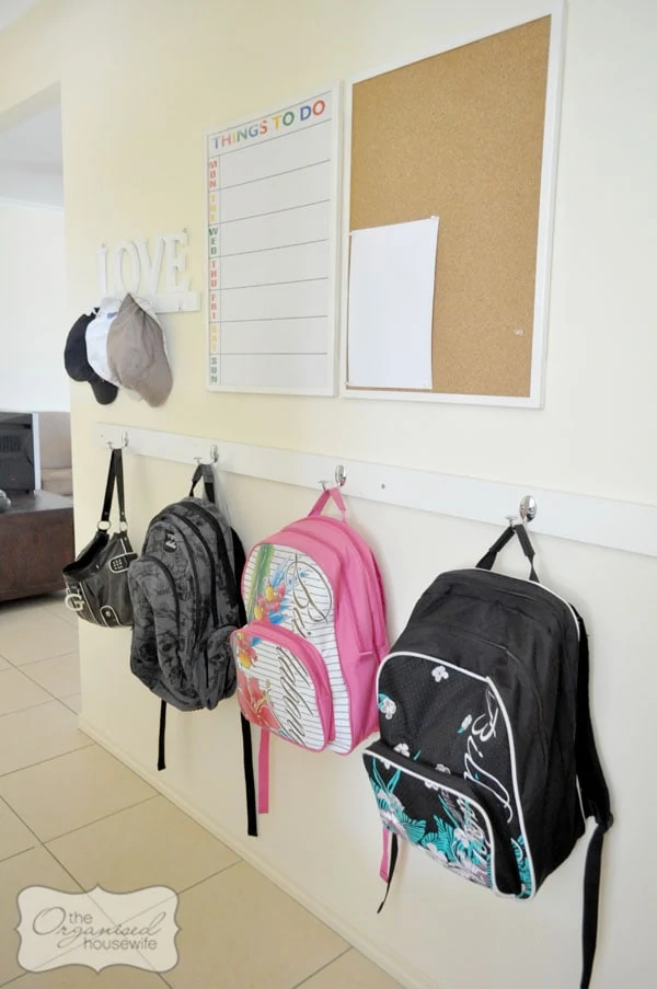 backpack storage command center with bulletin board and calendar on the wall