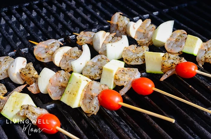 Lemon garlic shrimp skewers with mushrooms, onion, zucchini and tomatoes on the grill