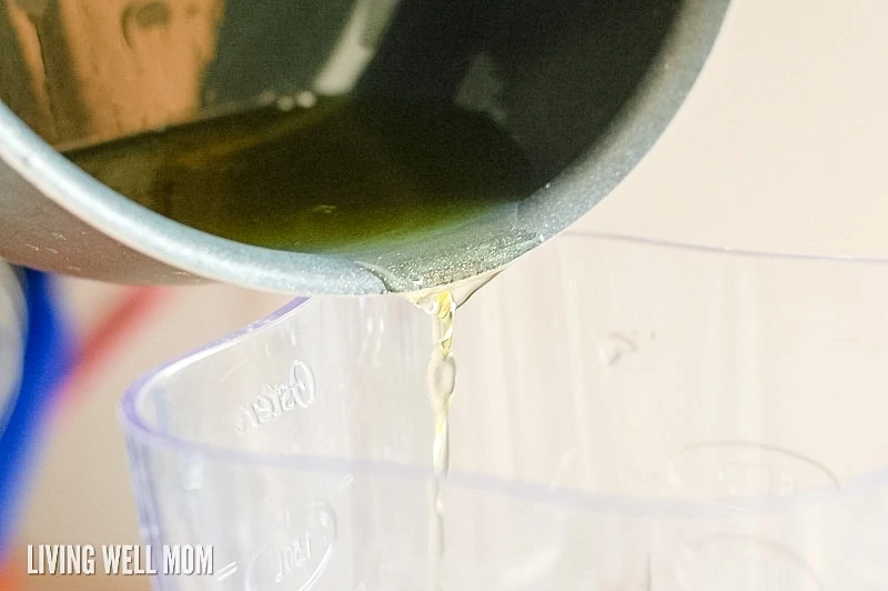 melted coconut oil and shea butter being poured into blender