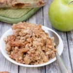 sugar-free Paleo apple crisp on a plate with a spoon