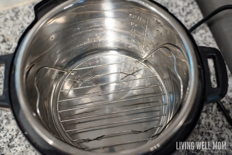 A view from above of an opened instant pot with a wire rack. 