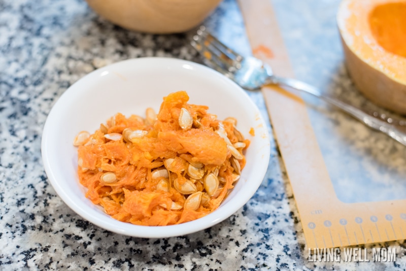 A bowl of the inside contents and seeds of a butternut squash. 