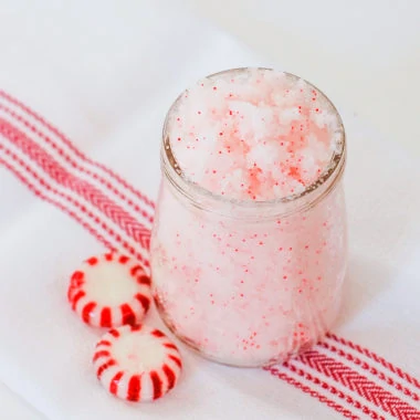 homemade peppermint sugar scrub in glass container with peppermint candies
